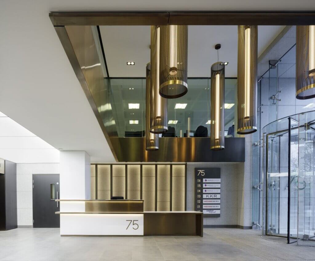 Lone stare funds reception. Steel Chandelier and wooden reception desk.